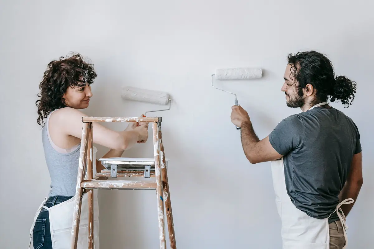 People painting a wall together — painting help in Cedar Rapids